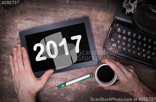 Image of Tablet touch computer gadget on wooden table - 2017