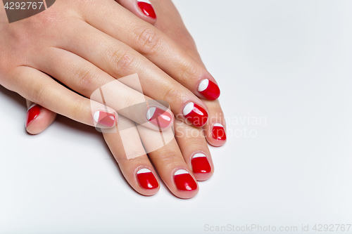 Image of Female hands with red and white nails