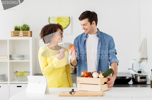 Image of happy couple with healthy food at home kitchen