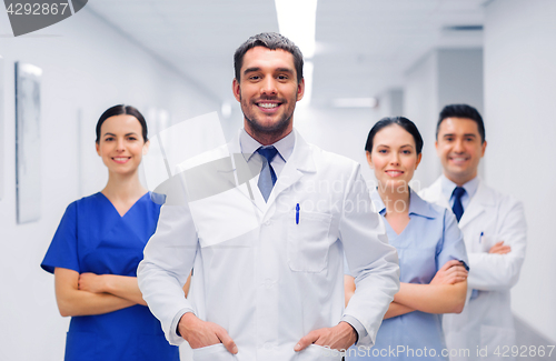 Image of happy group of medics or doctors at hospital