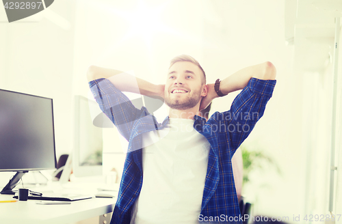 Image of happy creative man with computer at office