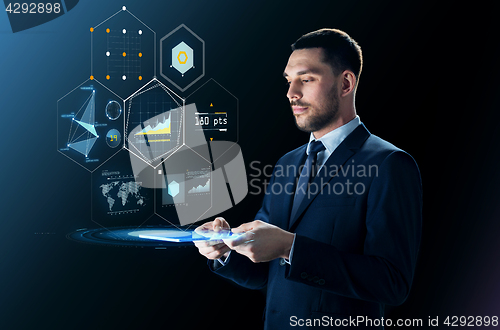 Image of businessman with tablet pc and virtual projection