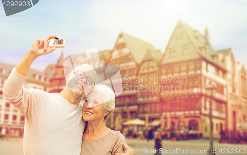 Image of senior couple with camera traveling in frankfurt