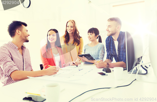 Image of happy creative team or students working at office