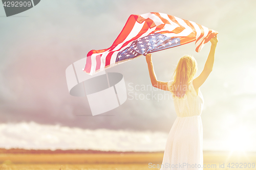 Image of happy woman with american flag on cereal field