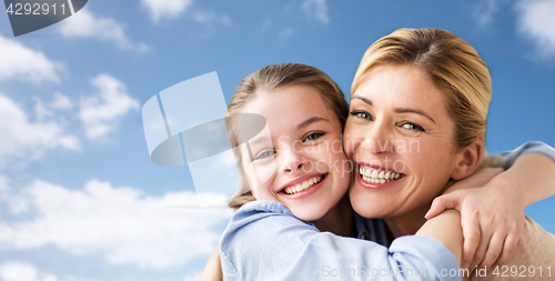 Image of happy family of girl and mother hugging over sky