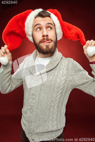 Image of Surprised christmas man wearing a santa hat