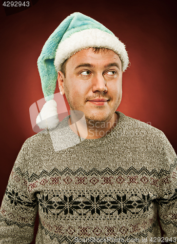 Image of Surprised christmas man wearing a santa hat