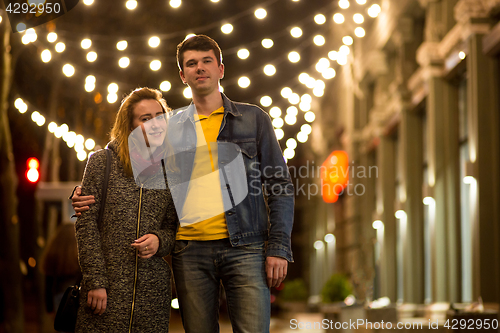 Image of Outdoor portrait of young beautiful happy smiling couple posing on street.