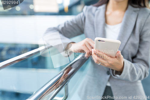 Image of Business woman working on cellphone