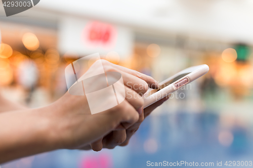 Image of Finger touching on mobile phone