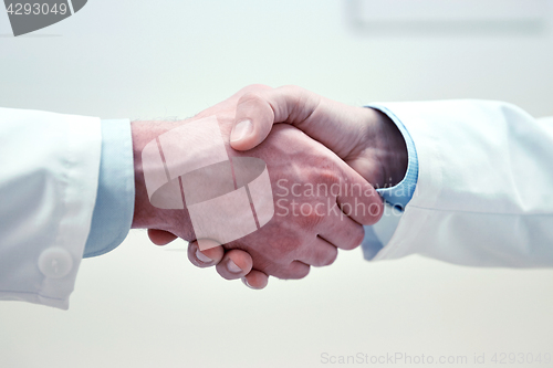 Image of close up of doctors hands making handshake