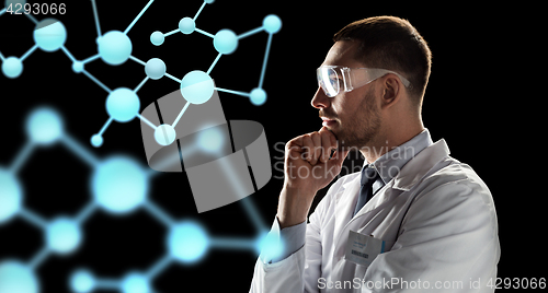 Image of scientist looking at molecule projection