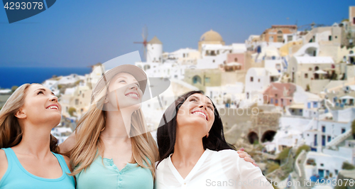 Image of happy women over santorini island background