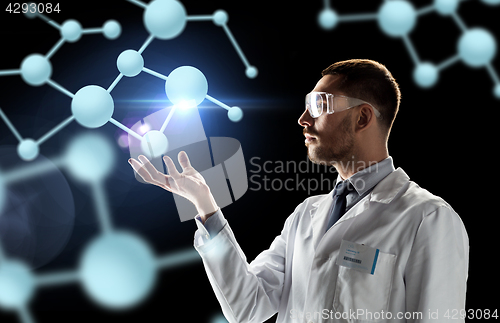 Image of scientist in lab coat and goggles with molecules