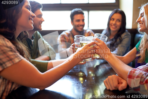 Image of happy friends drinking beer at bar or pub