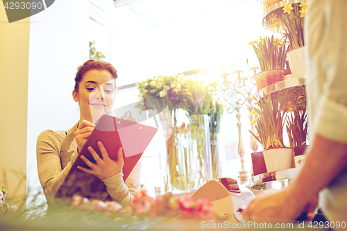 Image of florist woman and man making order at flower shop