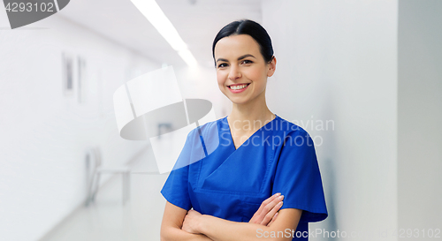 Image of happy doctor or nurse at hospital corridor