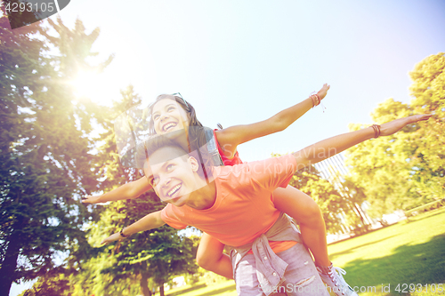 Image of happy teenage couple having fun at summer park