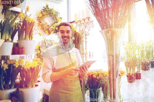 Image of man with tablet pc computer at flower shop