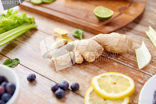 Image of ginger, fruits, berries and vegetables on table