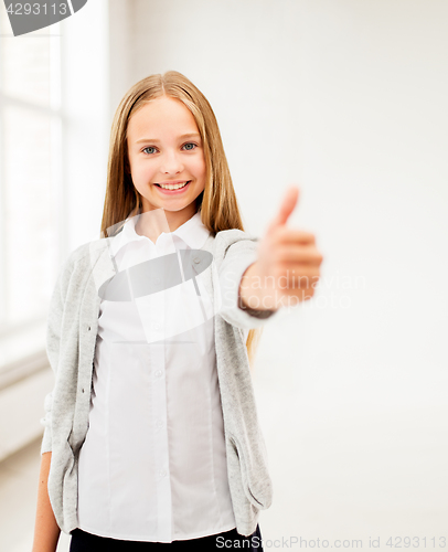 Image of happy smiling student girl showing thumbs up