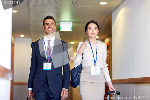 Image of business team with travel bags at hotel corridor