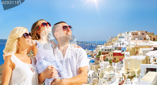 Image of happy family over santorini island background