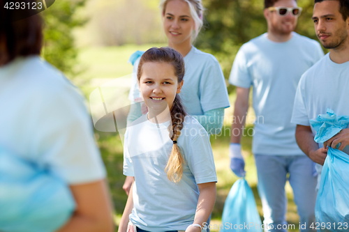 Image of volunteers with garbage bags outdoors