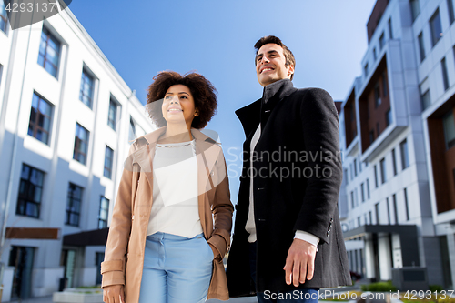 Image of happy international man and woman on city street