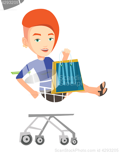 Image of Happy woman riding by shopping trolley.