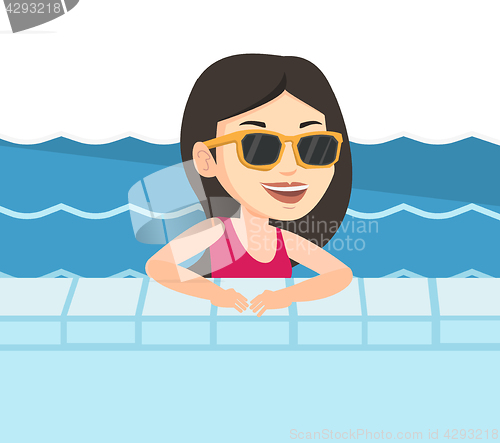 Image of Smiling young woman in swimming pool.