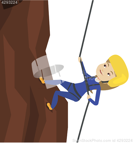 Image of Woman climbing in mountains with rope.