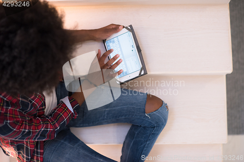 Image of black woman using her electronic tablet