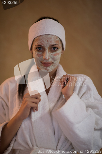 Image of Spa Woman applying Facial Mask