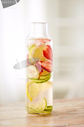 Image of close up of fruit water in glass bottle