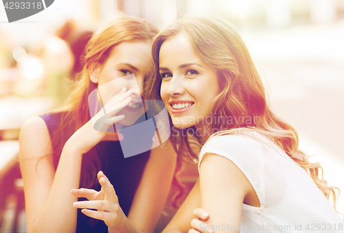 Image of young women drinking coffee and talking at cafe