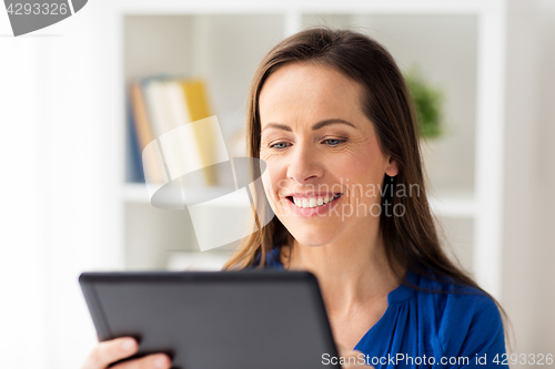 Image of woman with tablet pc working at home or office