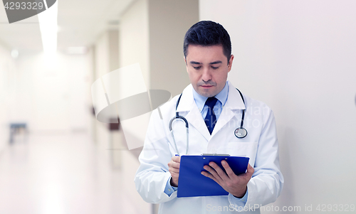 Image of doctor with clipboard at hospital corridor