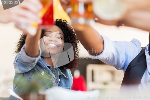 Image of friends clinking glasses with drinks at restaurant