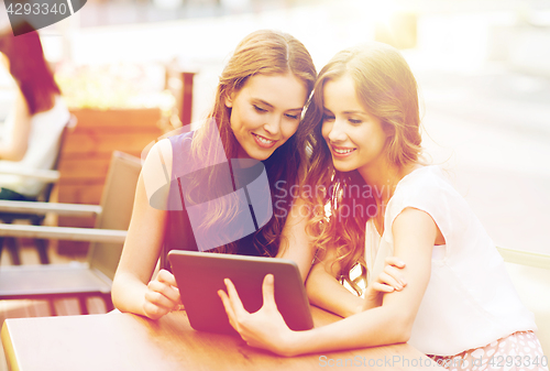 Image of happy young women or teenage girls with tablet pc
