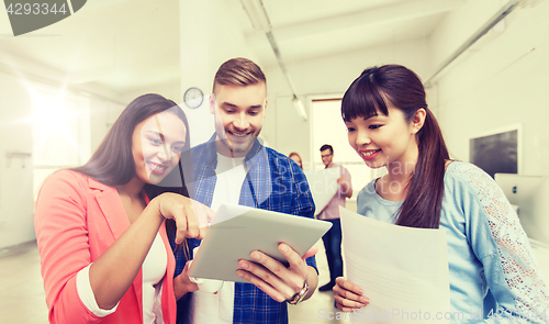 Image of creative team with tablet pc and papers at office