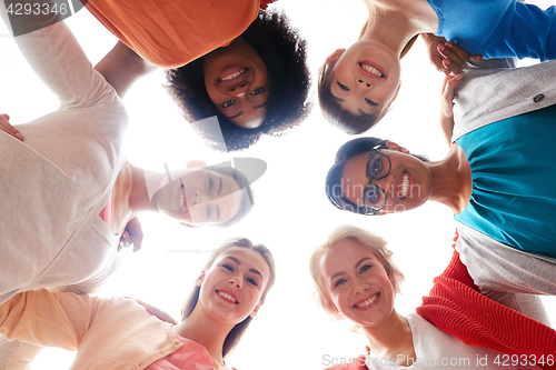 Image of international group of happy smiling women hugging