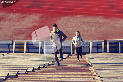 Image of couple running upstairs on stadium