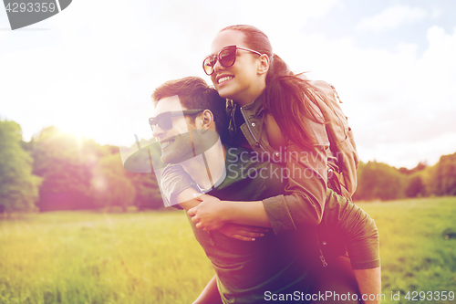 Image of happy couple with backpacks having fun outdoors