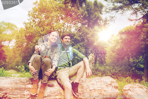 Image of smiling couple with backpacks in nature