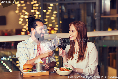 Image of couple dining and drinking wine at restaurant