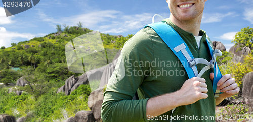 Image of close up of happy man with backpack traveling