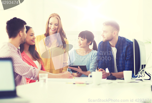 Image of happy creative team or students working at office
