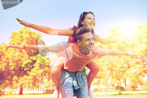 Image of happy teenage couple having fun at summer park